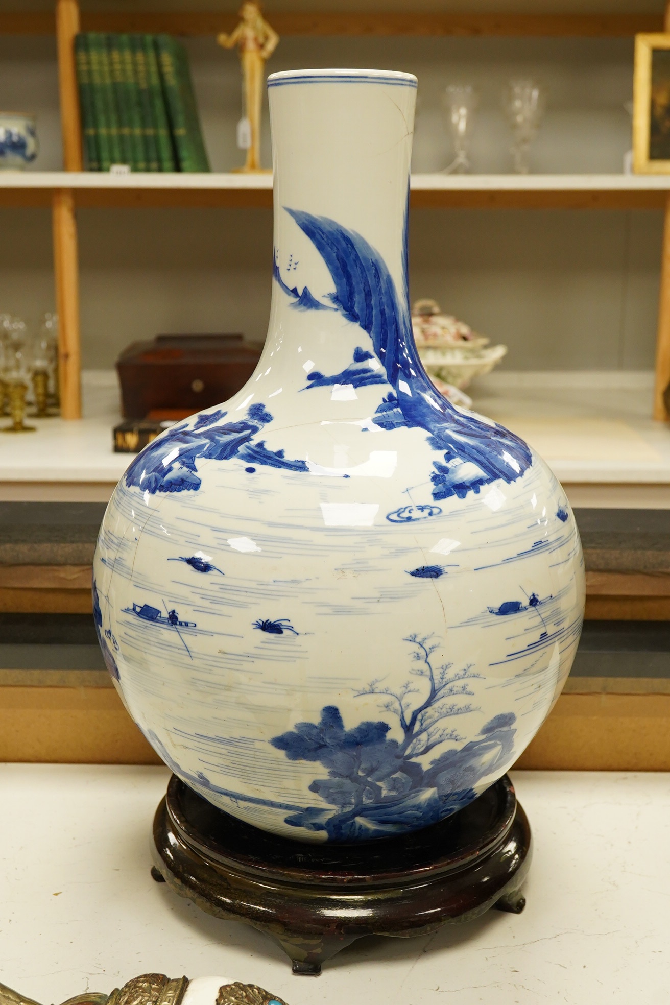 A Chinese blue and white bottle vase decorated with a landscape, 47cm high. Condition - poor